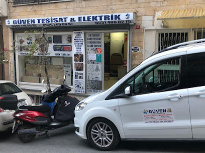 Güven Tesisat logolu servis aracı ve dükkânın dış cephesi